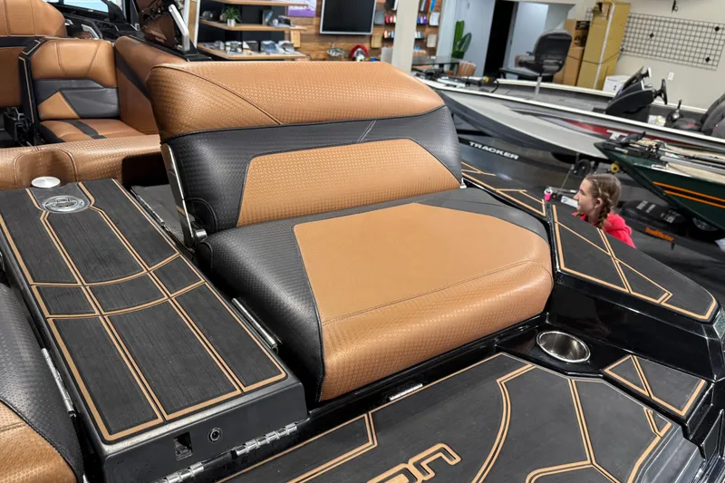 Slide: The Image of 2021 Centurion Ri265 boat interior with brown and black seating, showcasing luxury design. - 29
