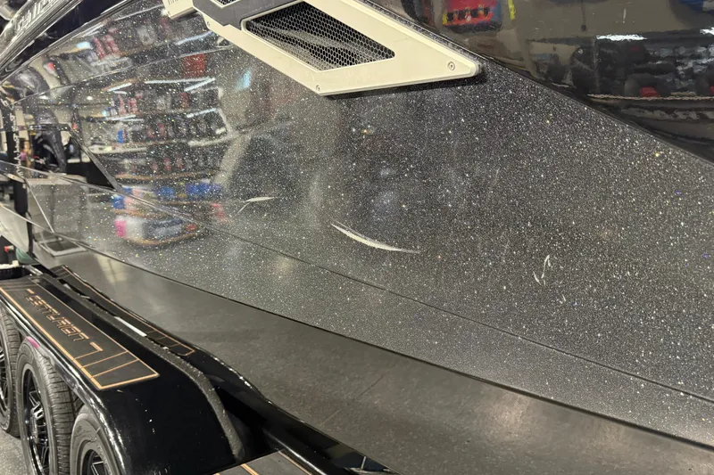 Slide: The Image of 2021 Centurion Ri265 boat with metallic finish on display in showroom. - 9