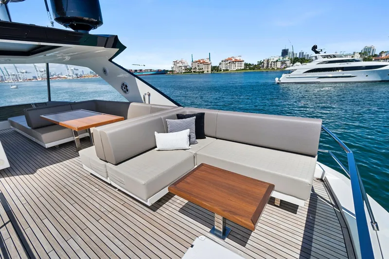 Slide: The Image of 2023 Astondoa 66 Flybridge yacht with elegant outdoor seating and scenic ocean view. - 10