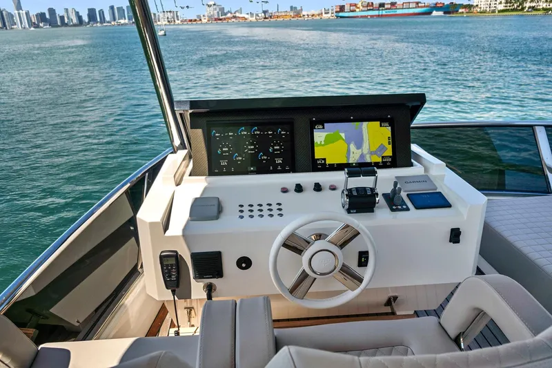 Slide: The Image of Flybridge helm of 2023 Astondoa 66, featuring modern navigation and control systems. - 13