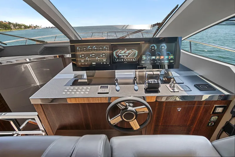 Slide: The Image of Luxurious helm of 2023 Astondoa 66 Flybridge yacht with advanced navigation controls. - 21