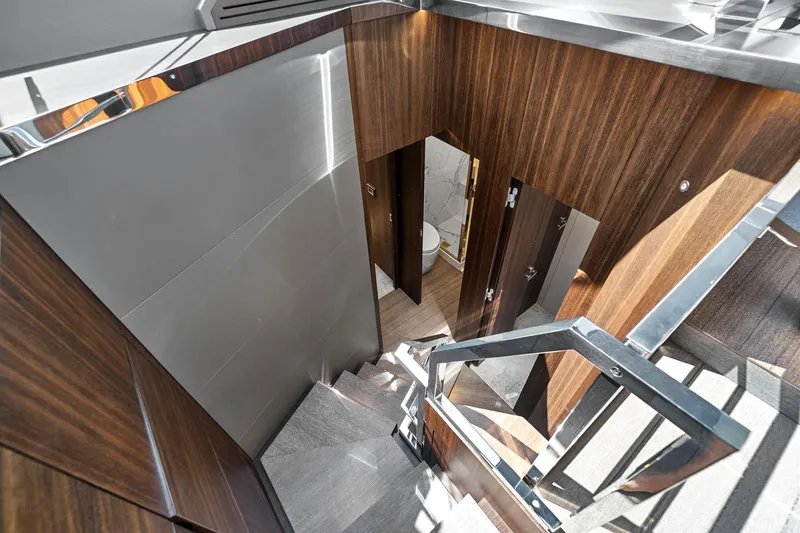 Slide: The Image of Staircase interior of 2023 Astondoa 66 Flybridge yacht with modern wood paneling. - 23