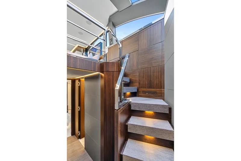 Slide: The Image of Luxurious interior staircase of 2023 Astondoa 66 Flybridge yacht with modern wood paneling. - 24