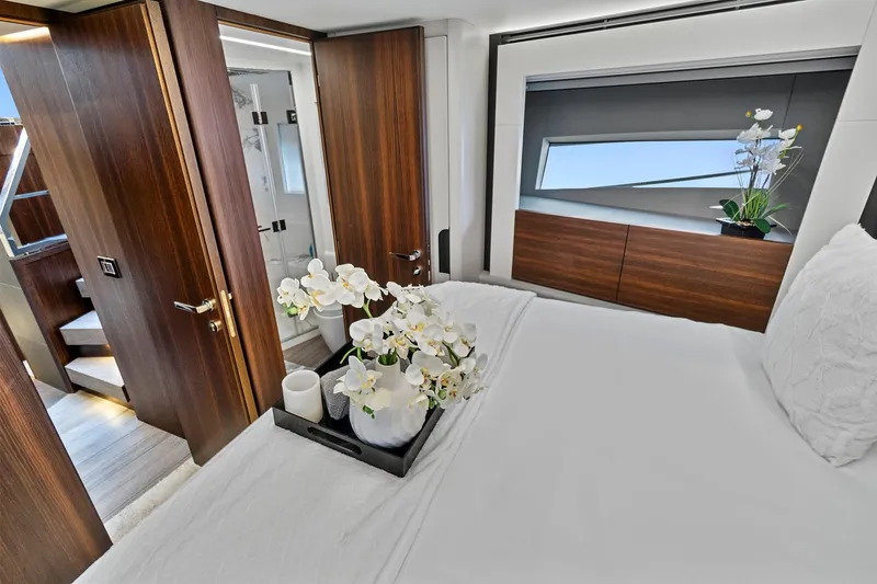 Slide: The Image of Luxurious bedroom interior of 2023 Astondoa 66 Flybridge yacht with elegant wood finishes. - 31