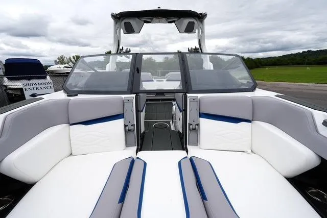 Slide: The Image of 2026 Supra SA boat interior with white and blue seating, open-air design, and modern dashboard. - 10