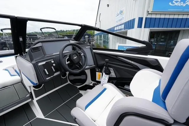 Slide: The Image of 2026 Supra SA boat interior with modern dashboard and seating, displayed at dealership. - 12