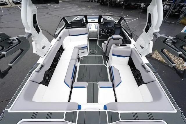 Slide: The Image of 2026 Supra SA boat interior with sleek white and gray seating, modern design. - 16