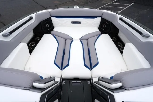 Slide: The Image of 2026 Supra SA boat interior with white and gray seating, blue accents, and cup holders. - 8