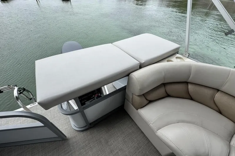 Slide: The Image of 2007 Manitou Aurora boat seating with beige upholstery and cup holders. - 10