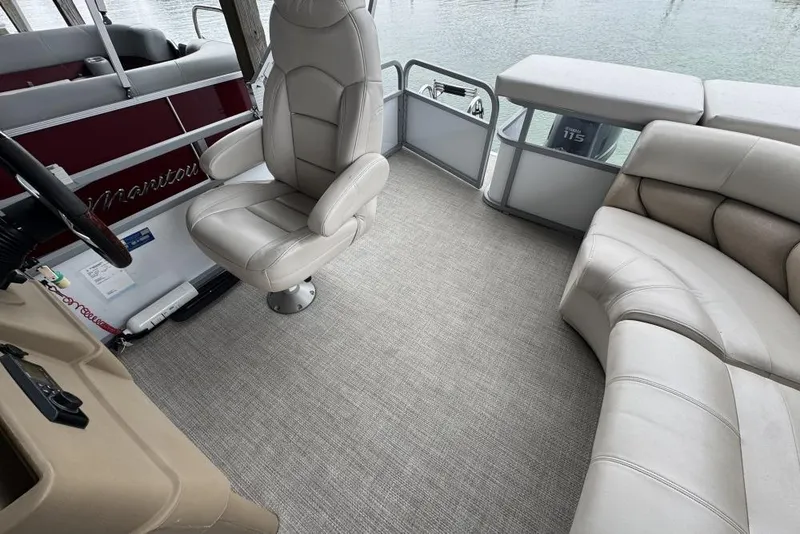 Slide: The Image of 2007 Manitou Aurora boat dashboard with Garmin GPS and wood-accented steering wheel. - 12