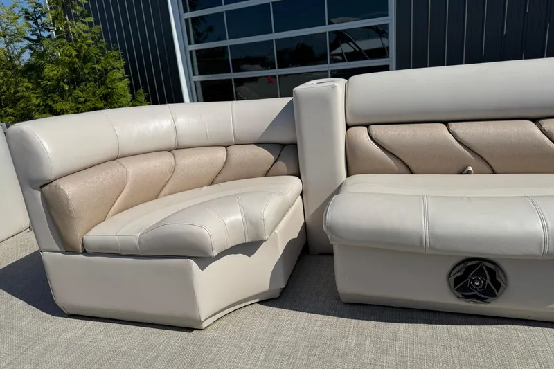 Slide: The Image of 2007 Manitou Aurora boat seating with beige upholstery and integrated speaker. - 14