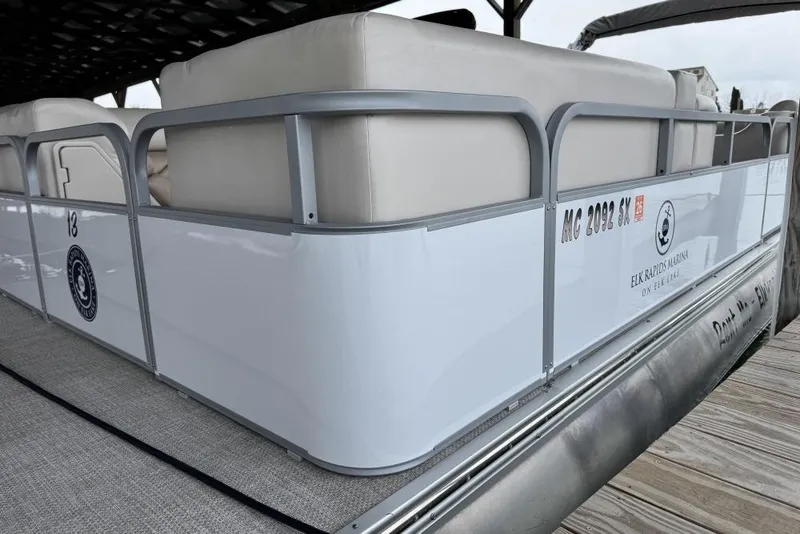 Slide: The Image of 2007 Manitou Aurora pontoon boat at Elk Rapids Marina, available for rent. - 2