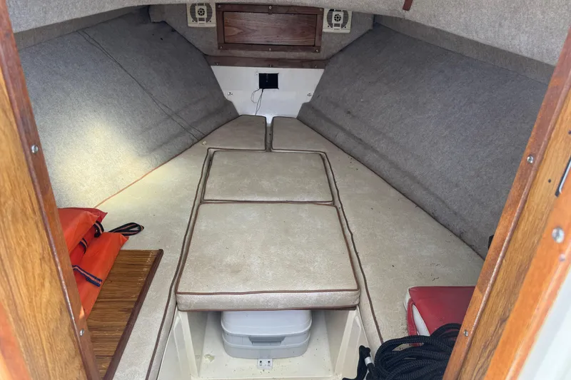 Slide: The Image of Interior cabin of a 1986 Mako Express boat with seating and storage. - 5