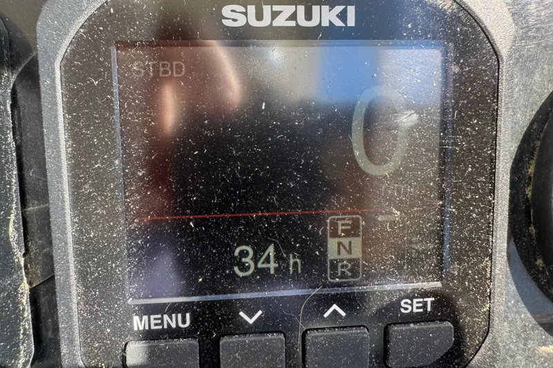 Slide: The Image of Suzuki display panel showing 34 hours on a 1986 Mako Express boat. - 6