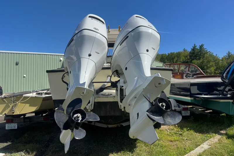 Slide: The Image of 1986 Mako Express boat with dual outboard motors, parked outdoors. - 8