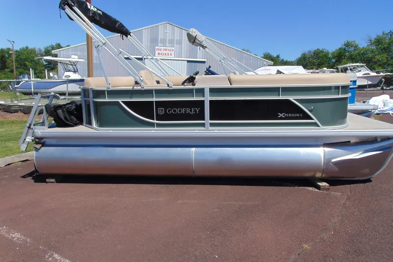 Slide: The Image of 2026 Godfrey EX 1880CX pontoon boat displayed outdoors on a sunny day. - 2
