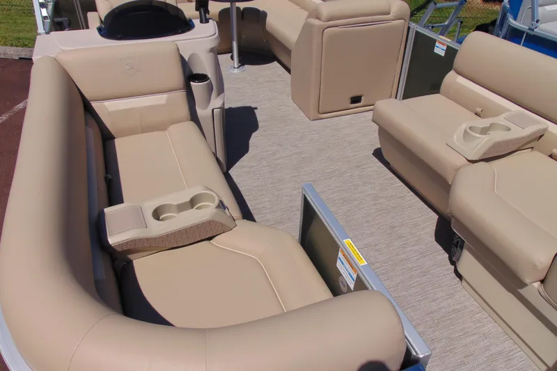 Slide: The Image of 2026 Godfrey EX 1880CX pontoon boat interior with beige seating and cup holders. - 5