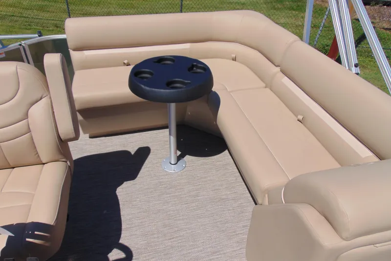 Slide: The Image of 2026 Godfrey EX 1880CX pontoon boat interior with beige seating and cupholder table. - 7