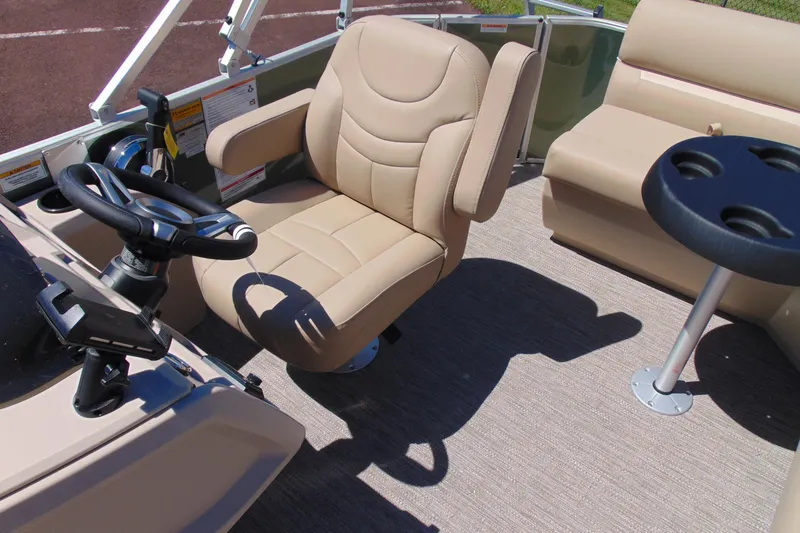 Slide: The Image of 2026 Godfrey EX 1880CX boat interior with beige seating and steering wheel. - 8