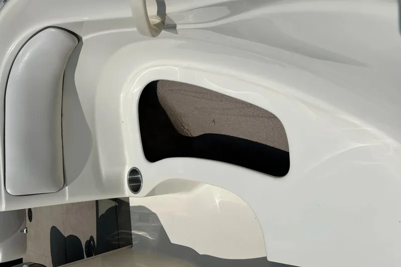Slide: The Image of 2003 Sea Ray 182 SRX Bow Rider interior seating, white upholstery with black trim. - 11