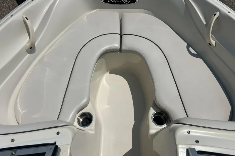 Slide: The Image of 2003 Sea Ray 182 SRX Bow Rider interior detail with storage compartment and cup holder. - 12