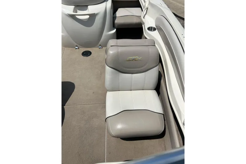 Slide: The Image of 2003 Sea Ray 182 SRX Bow Rider interior seating with cup holders. - 14