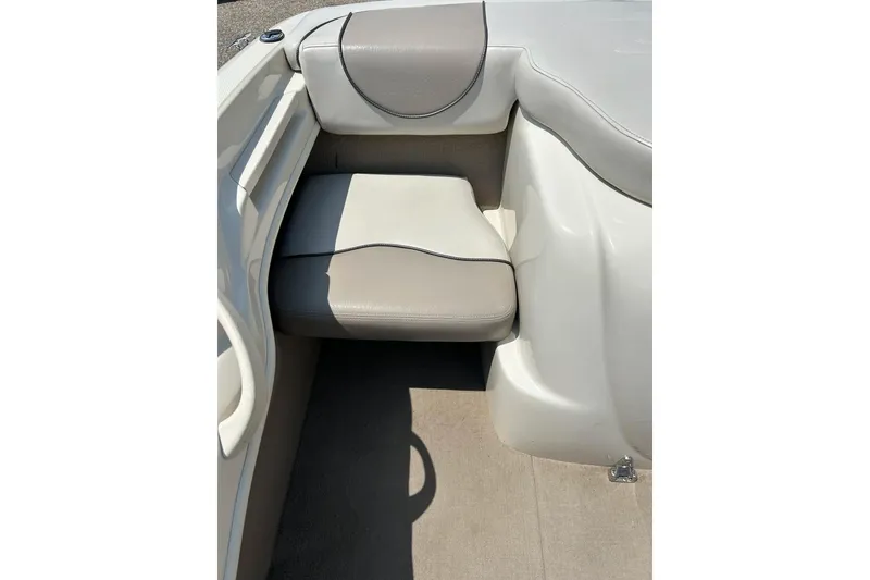 Slide: The Image of 2003 Sea Ray 182 SRX Bow Rider interior with beige seating and steering wheel. - 17