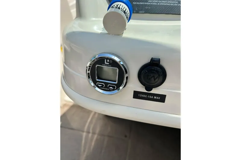 Slide: The Image of 2003 Sea Ray 182 SRX Bow Rider interior with cup holders and storage compartment. - 21