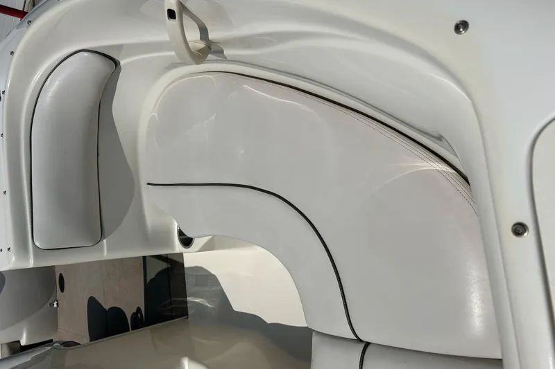 Slide: The Image of 2003 Sea Ray 182 SRX Bow Rider interior with beige seating and storage compartment. - 8