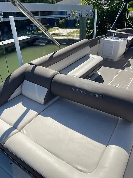 Slide: The Image of 2020 Bayliner Element XR7 boat interior with cushioned seating and sleek design. - 10