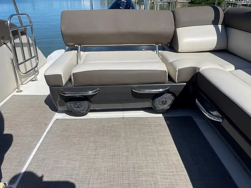 Slide: The Image of 2020 Bayliner Element XR7 boat seating area with cushioned seats and speakers. - 14