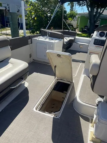 Slide: The Image of 2020 Bayliner Element XR7 interior with open storage compartment and seating. - 16