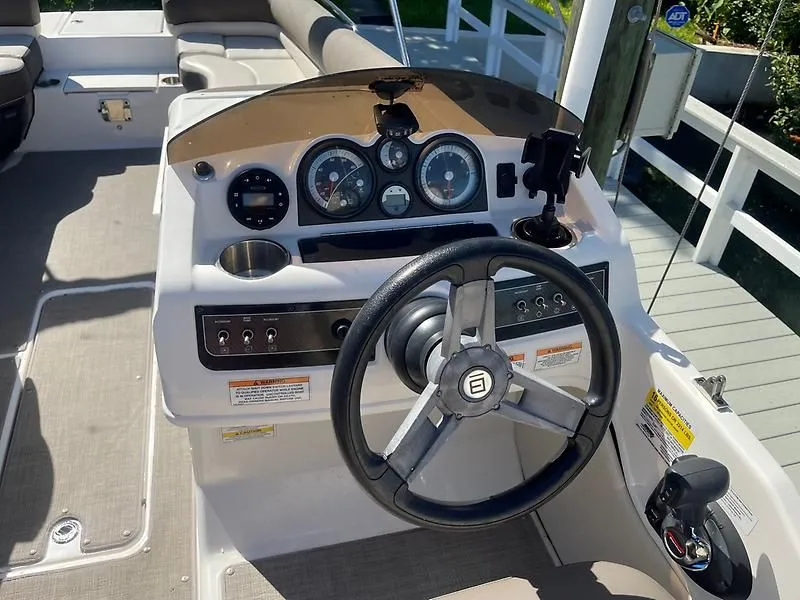 Slide: The Image of 2020 Bayliner Element XR7 boat dashboard with steering wheel and gauges. - 17