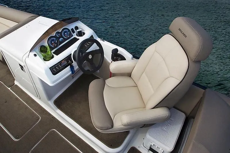 Slide: The Image of 2020 Bayliner Element XR7 helm with beige captain's chair and dashboard controls. - 18