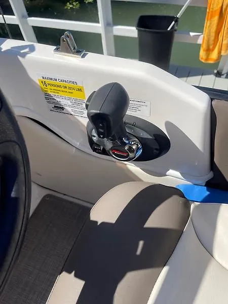 Slide: The Image of 2020 Bayliner Element XR7 boat throttle control and seating area. - 19