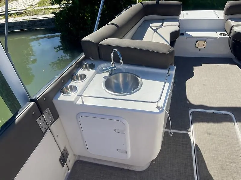 Slide: The Image of 2020 Bayliner Element XR7 boat interior with sink and seating area. - 23