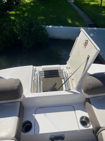 Slide: The Image of 2020 Bayliner Element XR7 boat with open storage compartment and seating area. - 24