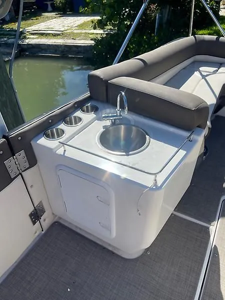 Slide: The Image of 2020 Bayliner Element XR7 boat interior with sink and seating area. - 29