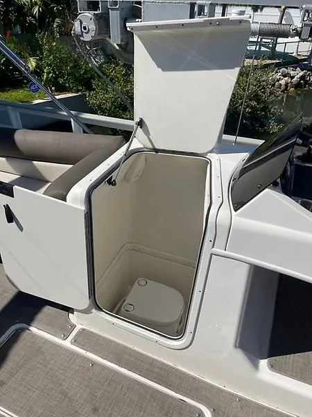 Slide: The Image of 2020 Bayliner Element XR7 boat with open storage compartment and toilet. - 32