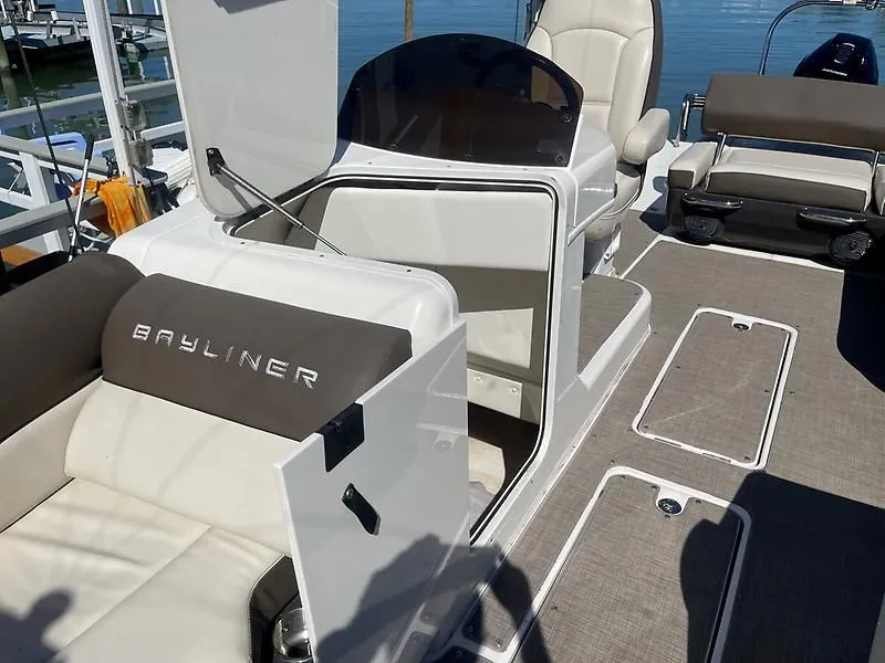 Slide: The Image of 2020 Bayliner Element XR7 boat interior with seating and open storage compartment. - 33