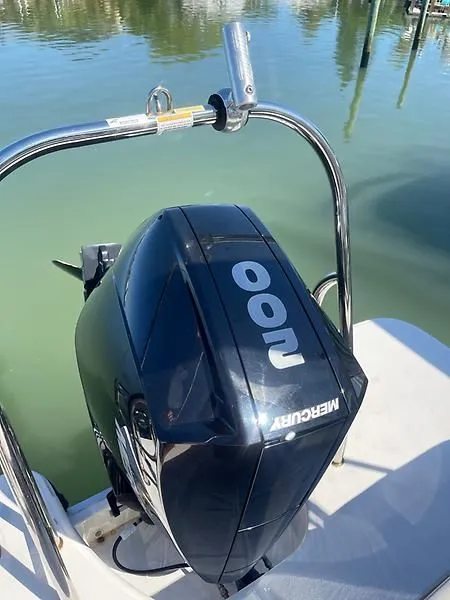 Slide: The Image of Outboard motor on 2020 Bayliner Element XR7 boat, docked on calm water. - 36