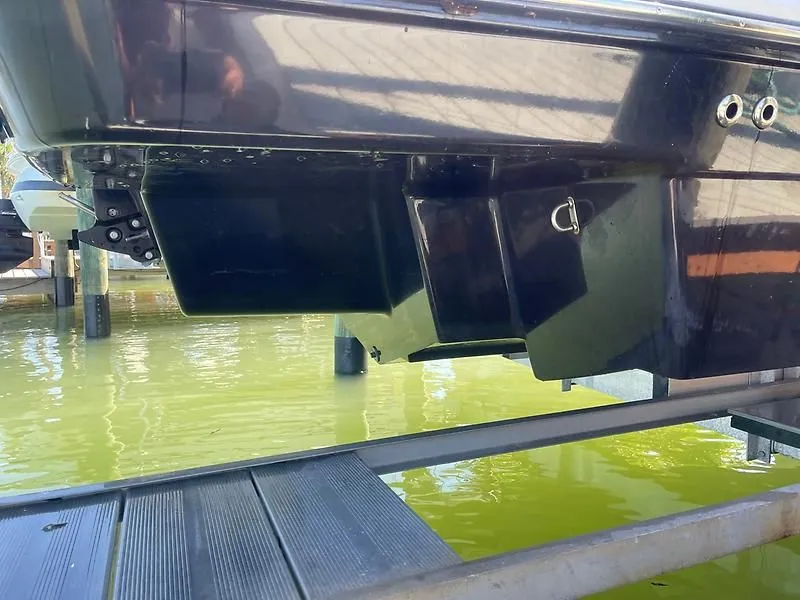 Slide: The Image of 2020 Bayliner Element XR7 boat hull on lift over green water. - 37