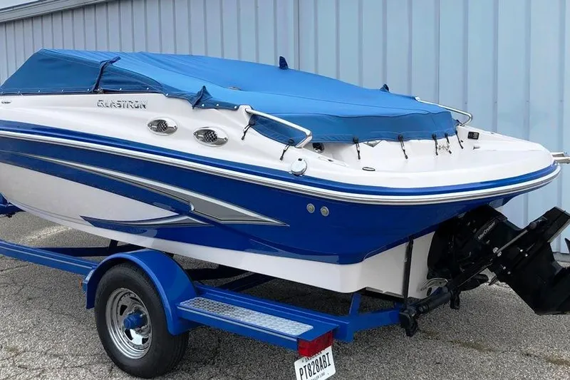 Slide: The Image of 2013 Glastron GLS 195 BR boat with blue cover on trailer. - 22