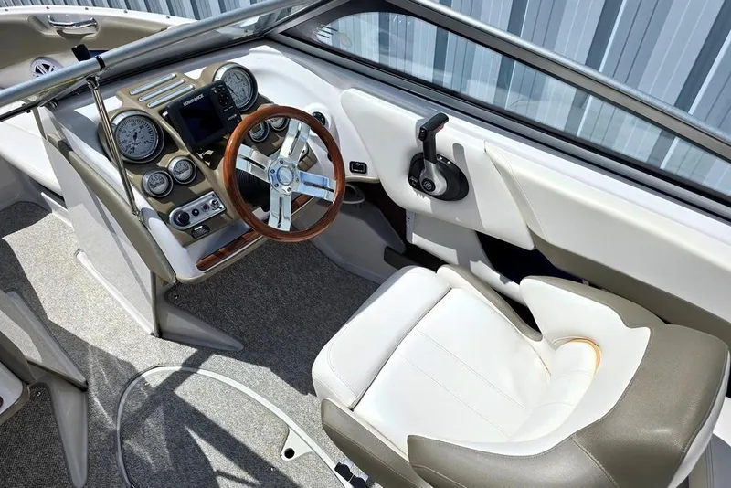Slide: The Image of 2013 Glastron GLS 195 BR boat interior with steering wheel and dashboard controls. - 3