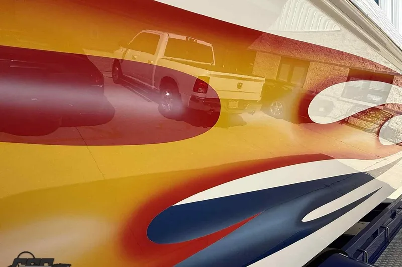 Slide: The Image of Colorful design on 2006 Fountain 47 Lightning boat with vehicle reflection. - 12