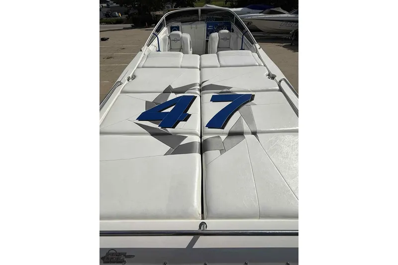 Slide: The Image of 2006 Fountain 47 Lightning boat with white seating and blue "47" design. - 16