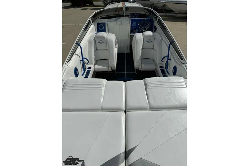 Slide: The Image of 2006 Fountain 47 Lightning boat interior with white seating and blue accents. - 20