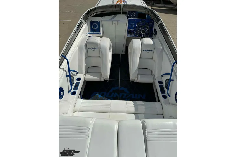 Slide: The Image of 2006 Fountain 47 Lightning boat interior with white seating and blue accents. - 21