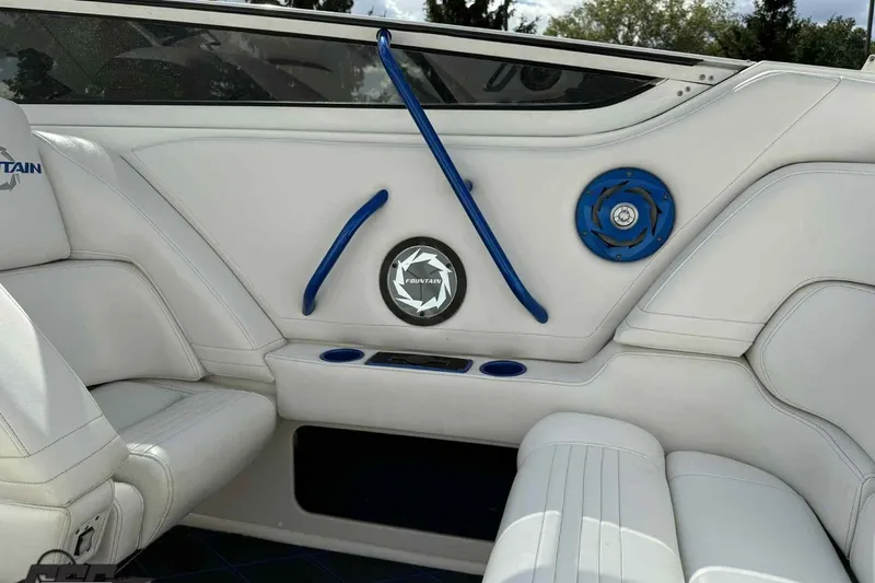 Slide: The Image of 2006 Fountain 47 Lightning boat interior with white seating and blue accents. - 25