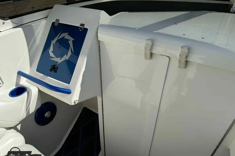 Slide: The Image of 2006 Fountain 47 Lightning boat interior with blue accents and storage compartment. - 28